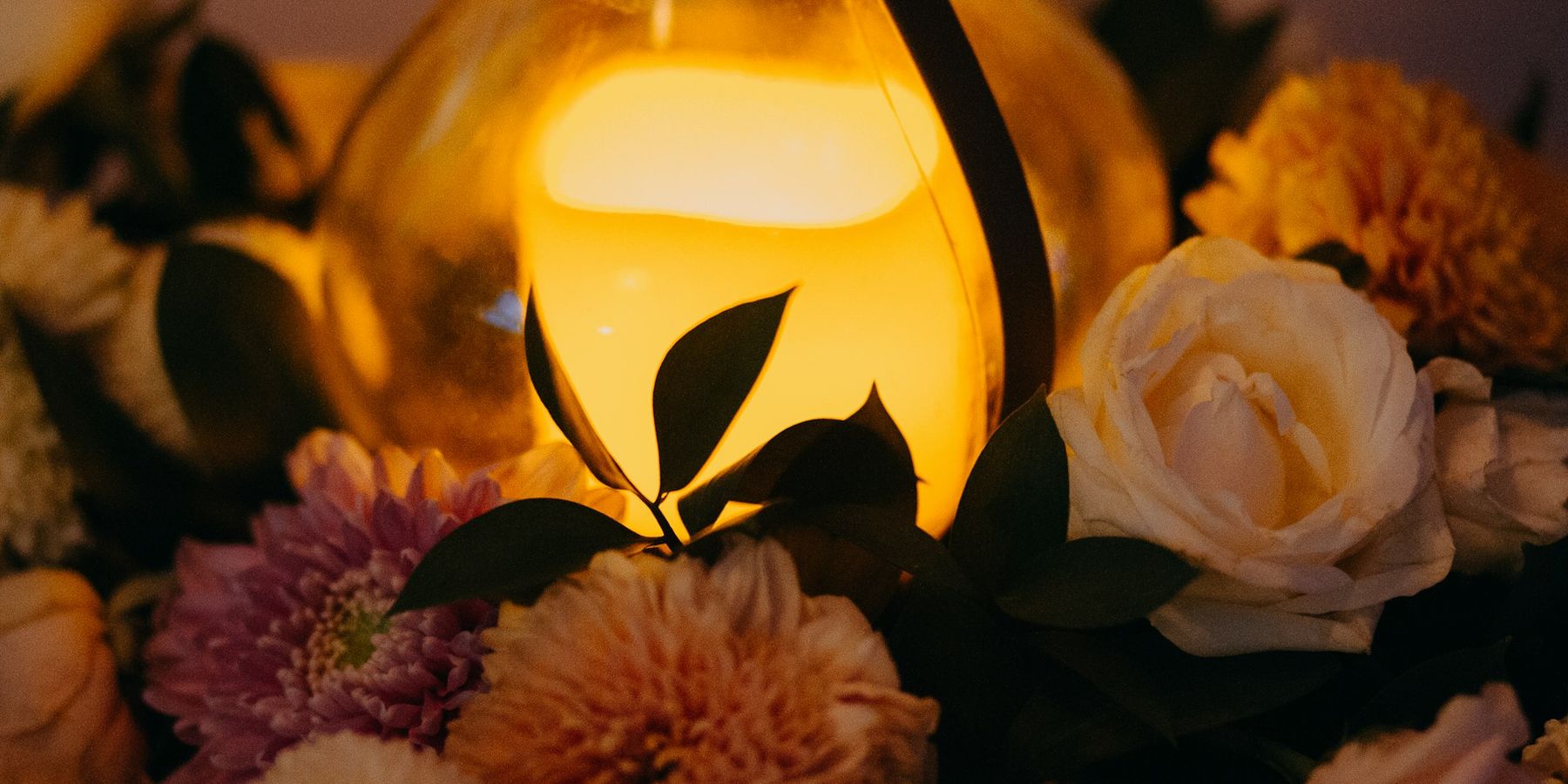 Candle and flowers at a memorial service