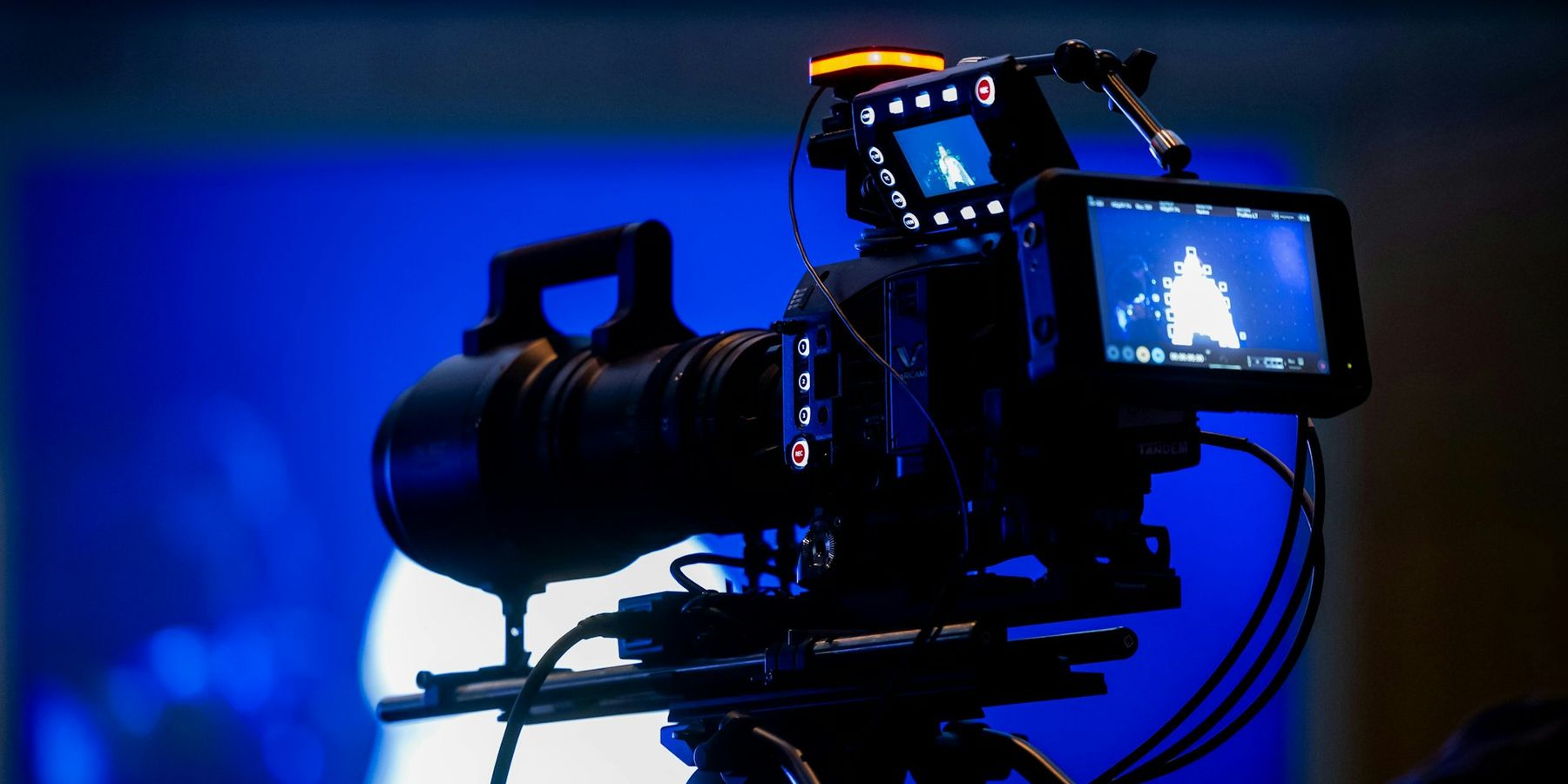 Professional video camera on a tripod at a live event